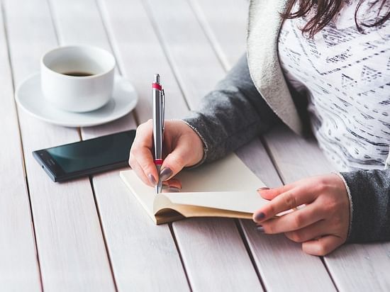 a woman taking notes
