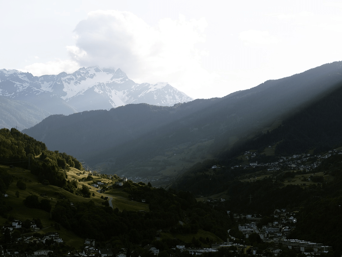 Scenic misty mountain valley with lush green hills and cloudy skies at Diamond Hotels Chandigarh.
