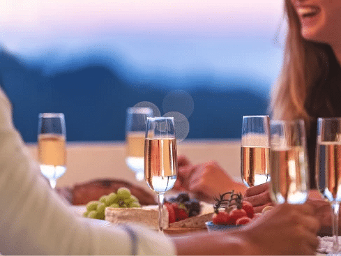 People toasting with champagne glasses during a sunset gathering - S Hotel Montego Bay, Jamaica