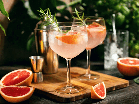 Refreshing cocktails garnished with citrus fruits and herbs on an outdoor bar - S Hotel Montego Bay, Jamaica