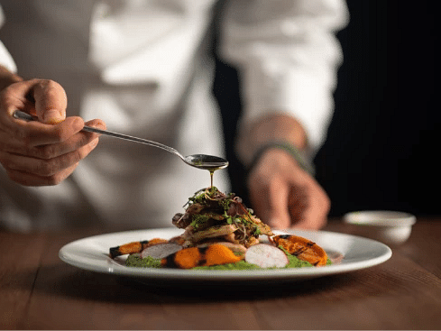 Gourmet dish being presented by a chef, featuring fine dining elements - S Hotel Montego Bay, Jamaica