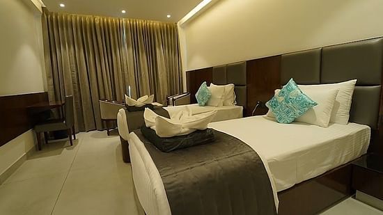 A side view of twin beds with bedding