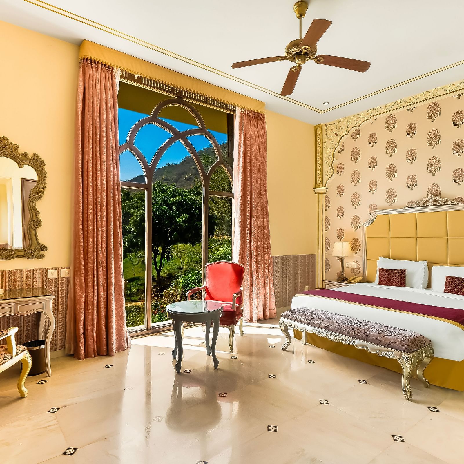 Elegant double bedroom at Rajasthali Resort Jaipur with plush interiors, arched windows, and royal decor touches.