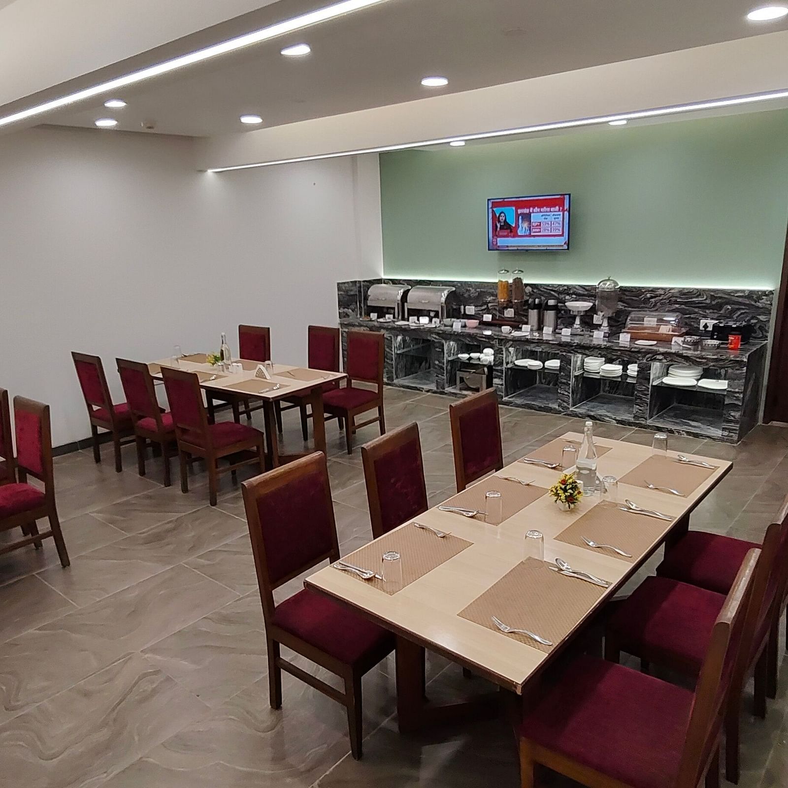 Restaurant-style dining area with red chairs and wooden tables