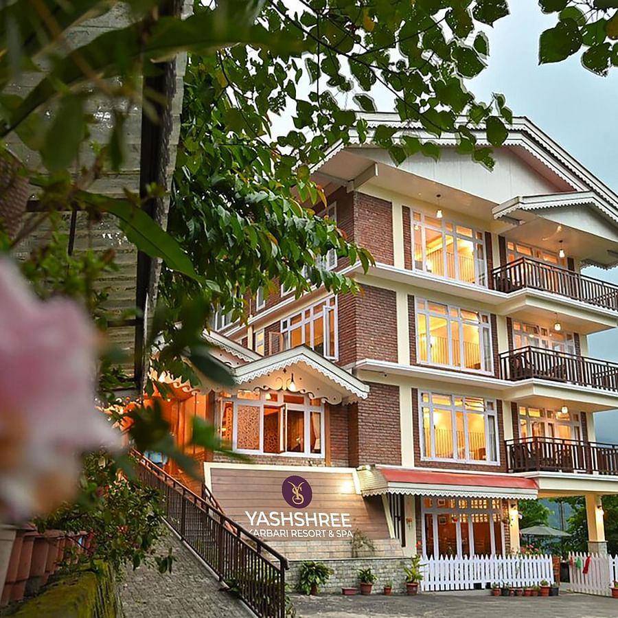a beautiful facade image of the Yashshree Karbari Resort & Spa, Yangang with cloudy overcast skies in the background