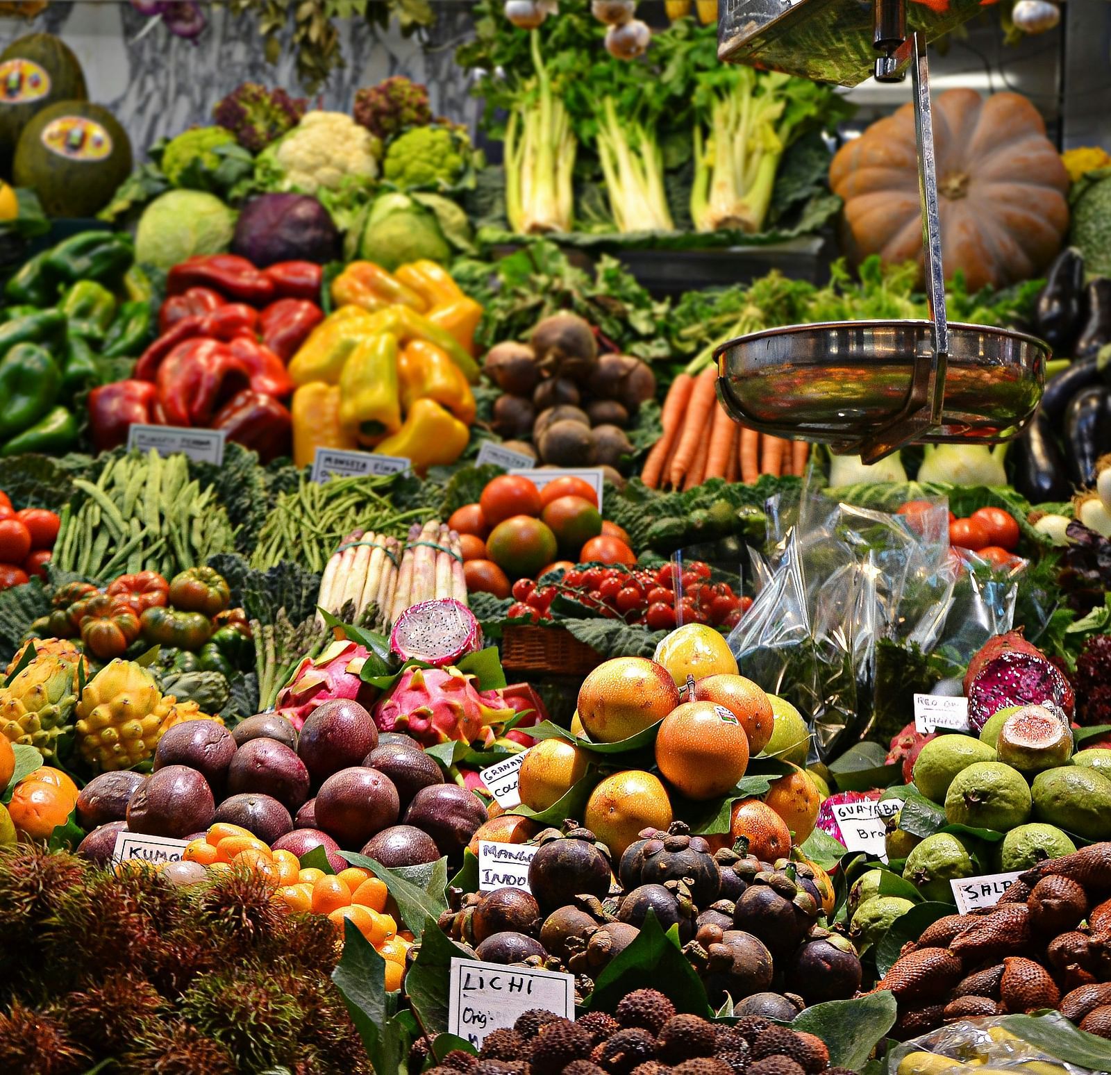 A close up shot of a fruit stall with different kinds of fruits and vegetables on display