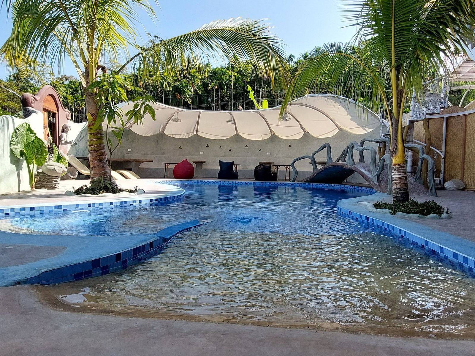 Tranquil retreat with a sparkling pool and lush tropical surroundings -Matsya Island Retreat by Island Quest. 