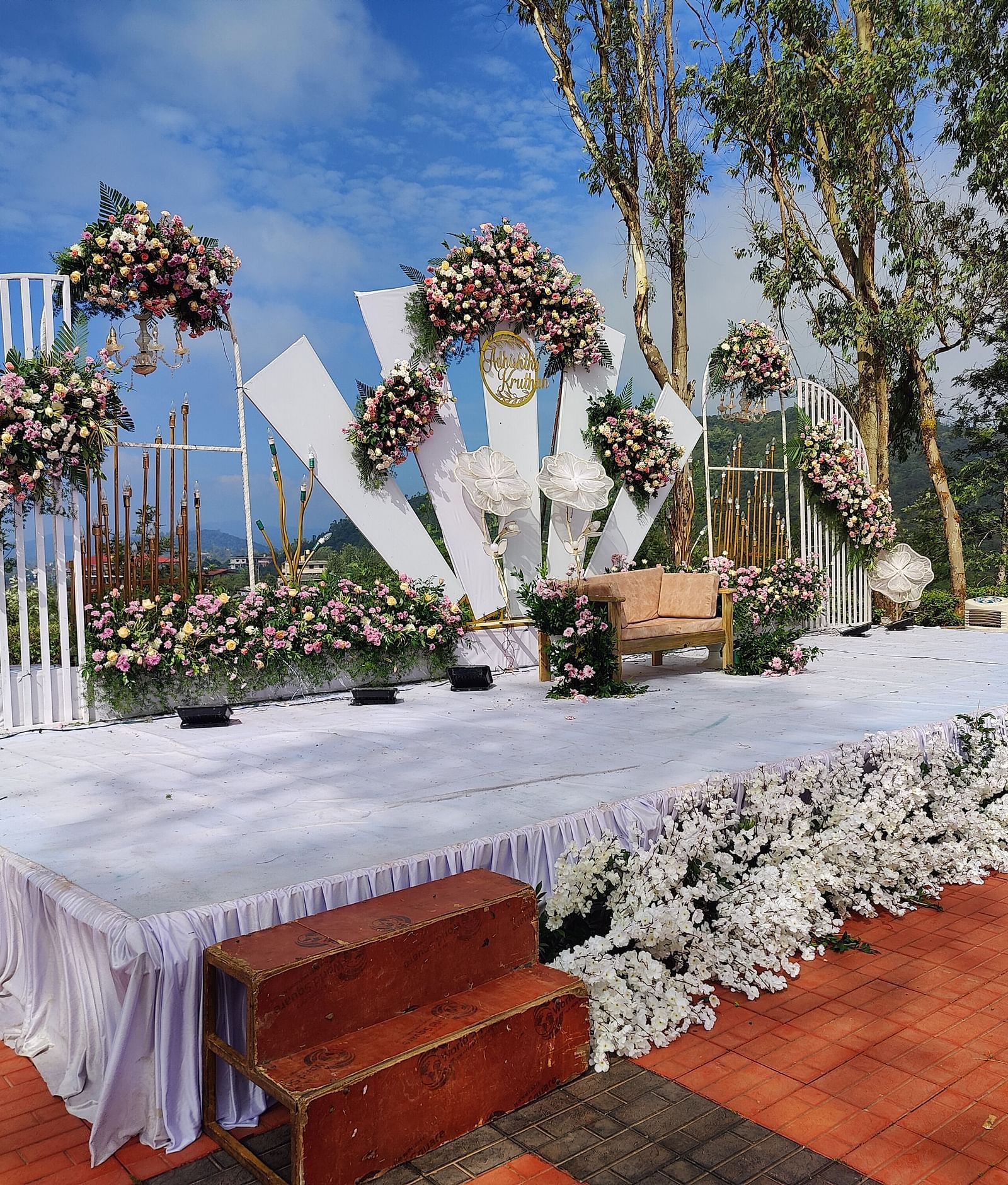 Outdoor reception area with decorated tables and floral backdrops | Open Deck