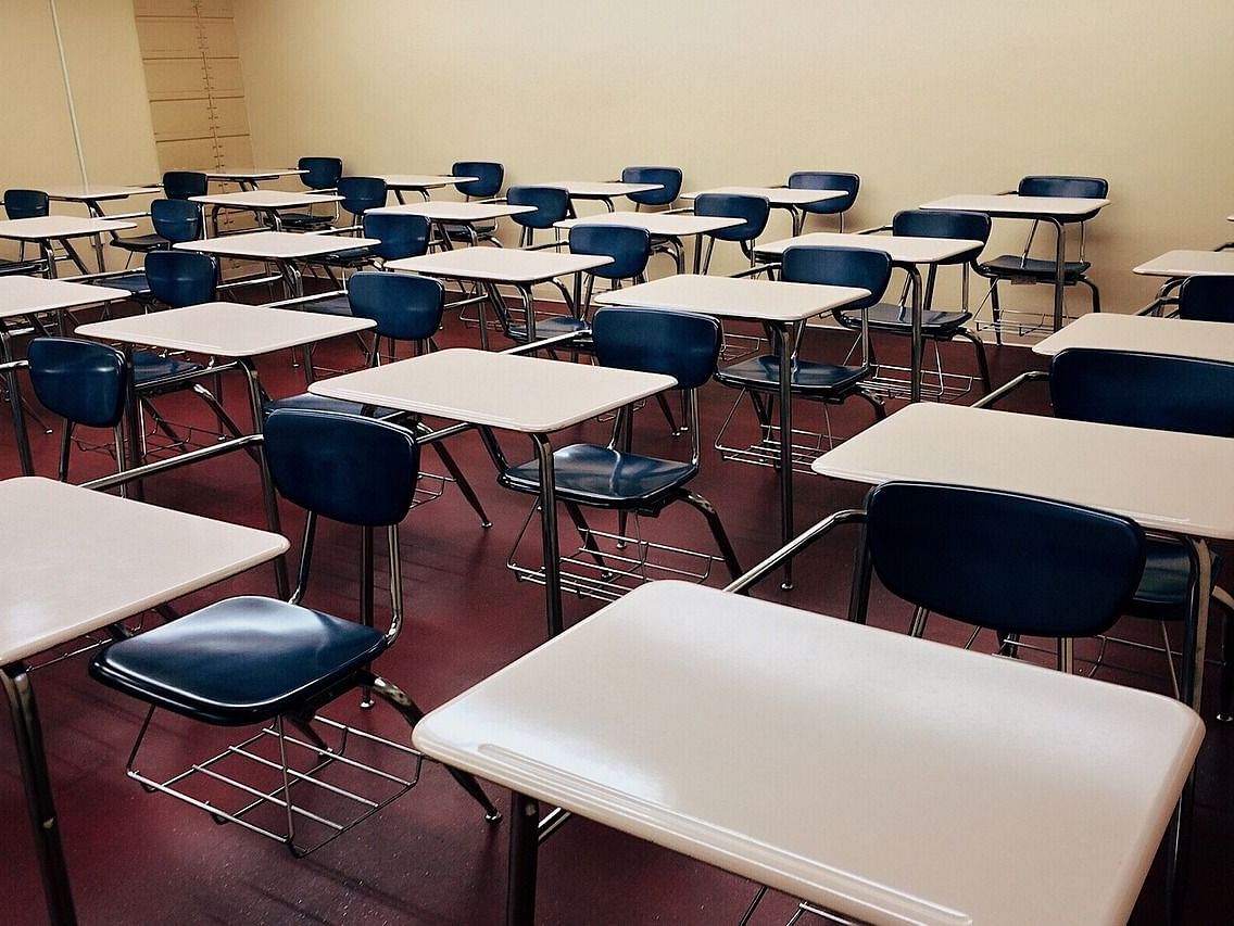 Classroom with tables and chairs arranged separately, each piece of furniture positioned individually.