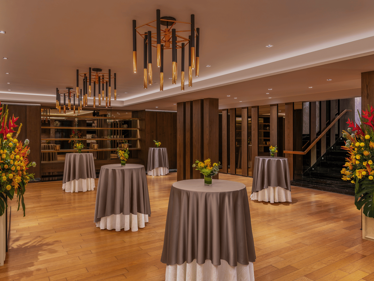 Banquet hall with round tables, chairs, and floral decorations at The Raintree, St. Mary’s Road.