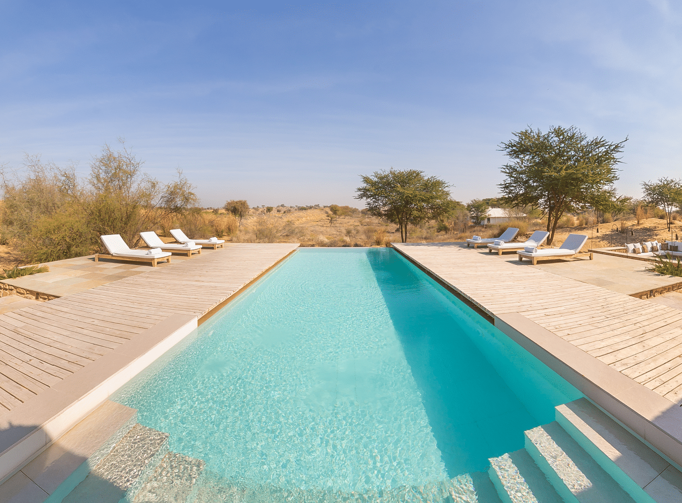 Swimming pool with lounge chairs during the day