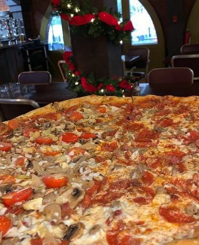 a close up image of a huge pizza with a lot of pepperoni -  Historic Tapoco Lodge 