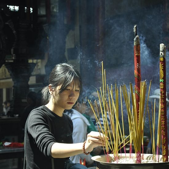 a shot of  a girl offering prayers at temples in prayagraj