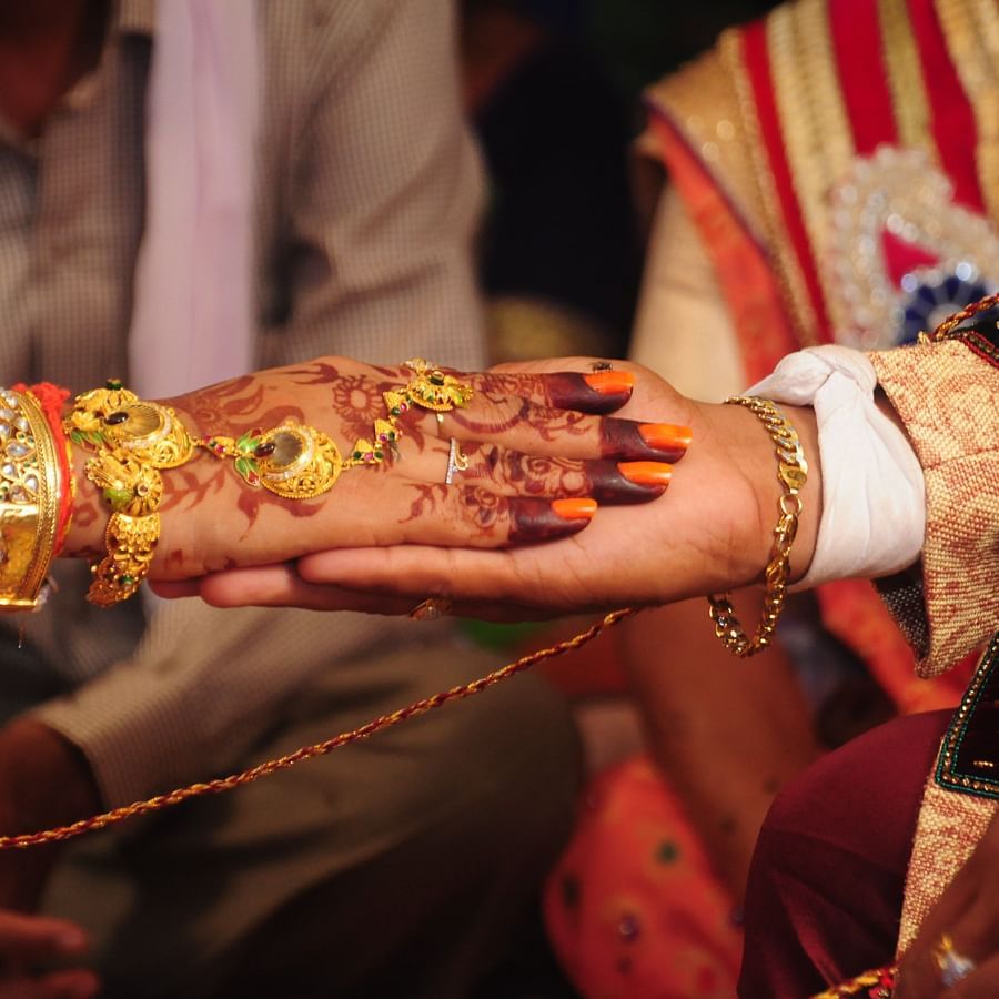 bride and groom holding hands during a wedding ritual