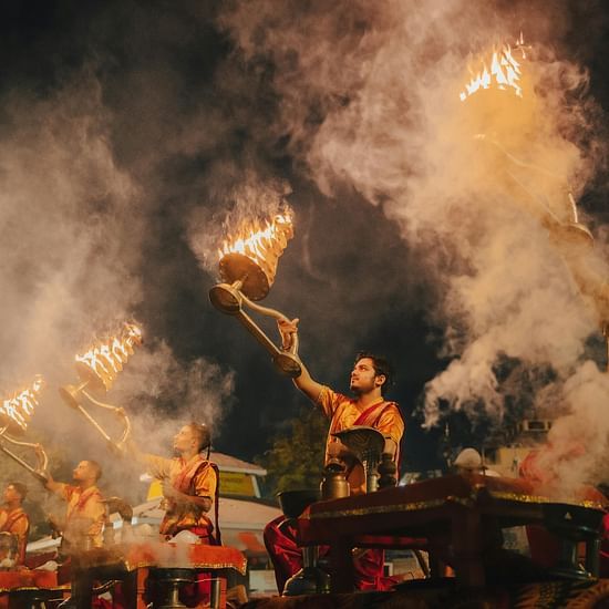 Image of priest doing Ganga Aarti by the bank of river Ganges at the evening.