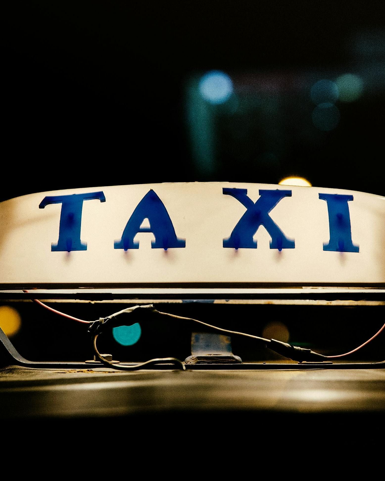 Illuminated taxi sign on a vehicle, possibly for guest transport or decor element at Rang Lords Inn.