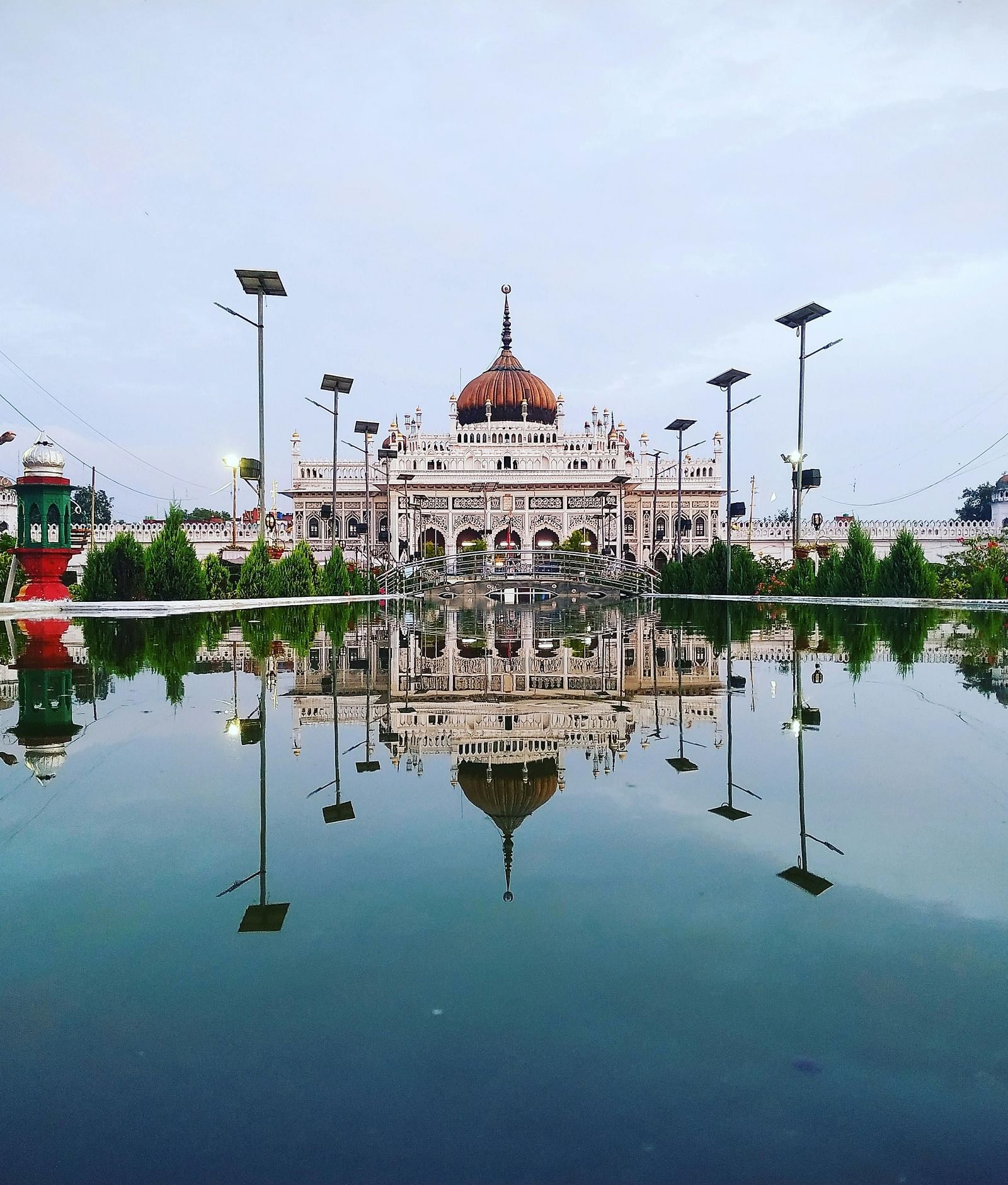 A picturesque view of Chota Imambada reflection in a still pool, emphasising the harmony between architecture and nature