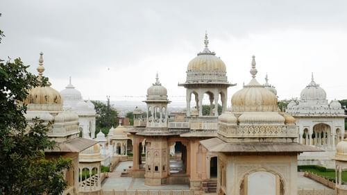 An overview of many cenotaphs on buildings with white clouds in the background