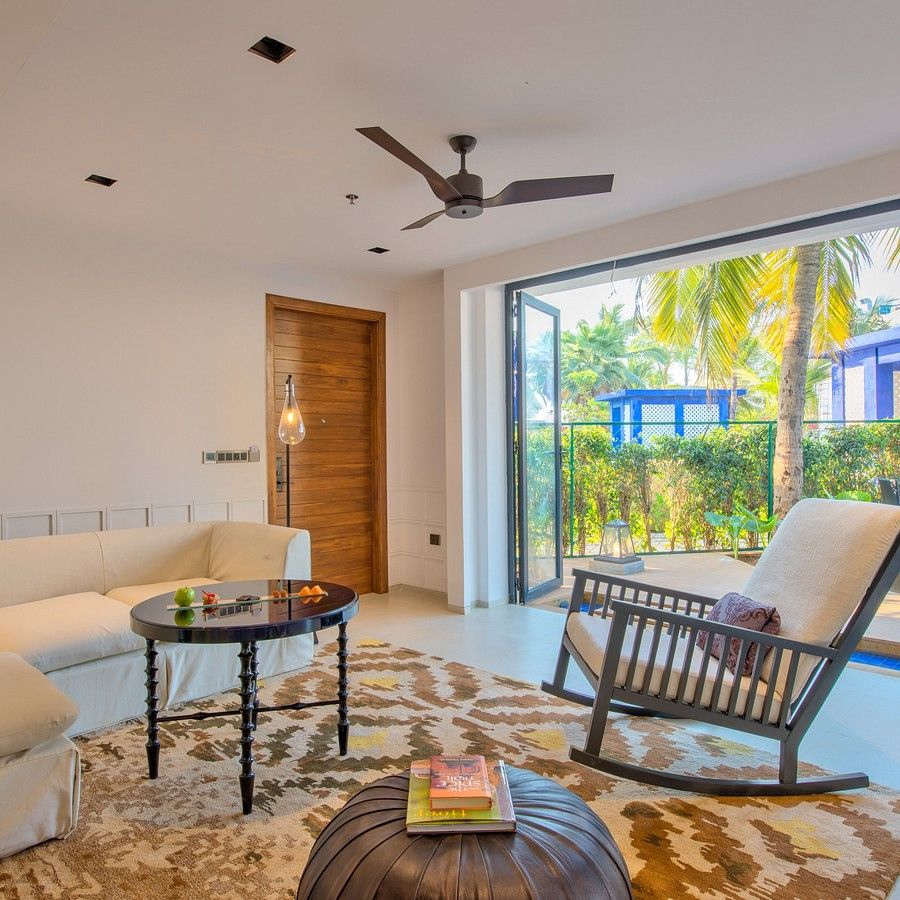alt-text Room interiors with a rocking chair, pouffe, table and couch