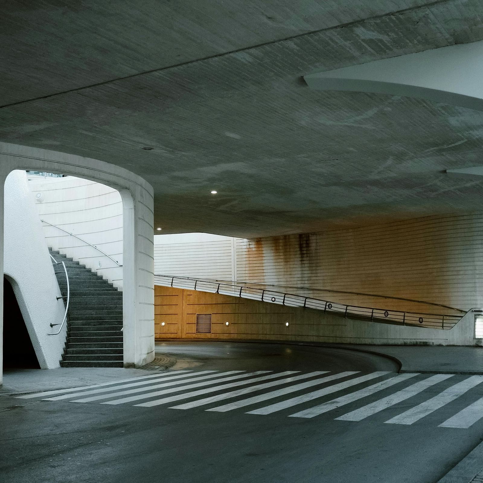An image of a basement parking area with staircase leading to the upper level