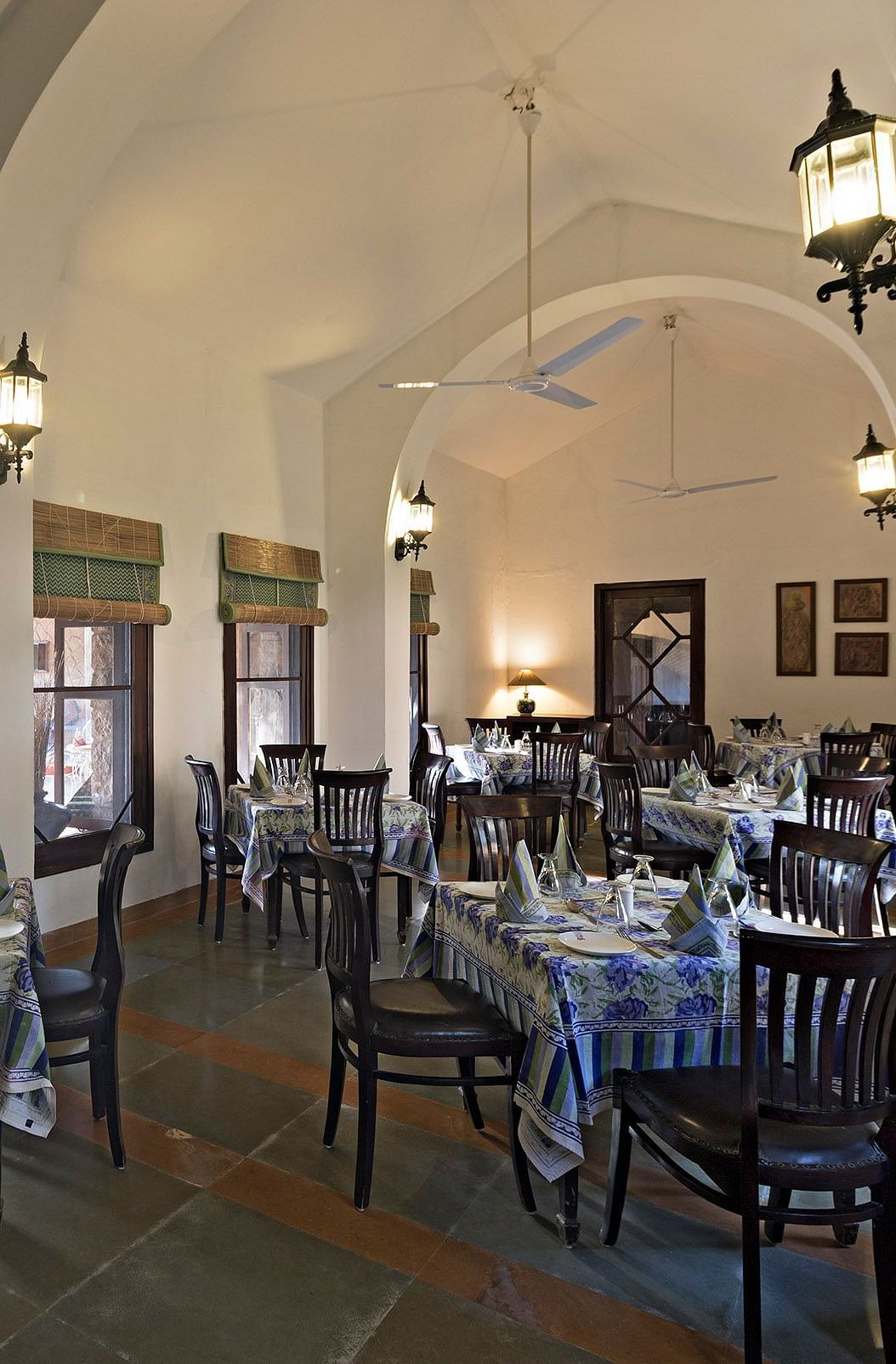 An image of the seating arrangement at with minimal decoration Taasli Restaurant of Manvar Shergarh - Manvar Resort & Desert Camp