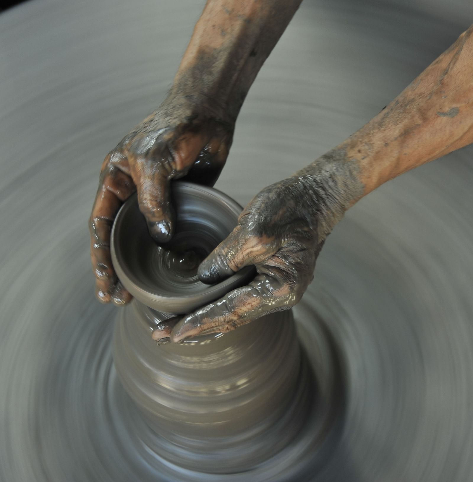 A pair of hands doing pottery