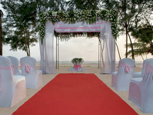 A glimpse of Sea Mist with a podium for exchanging vows and seating arrangement in front of it - Kenilworth Resort and Spa