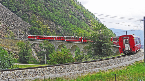 Colourful train surrounding beautiful mountains