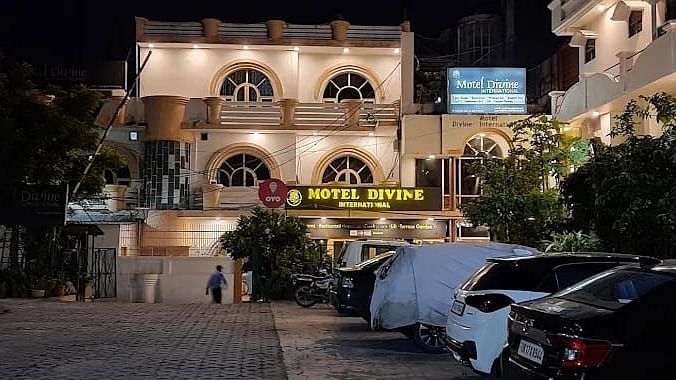 A nigh time view of our hotel illuminated by bright lights and a signage representing the name of the hotel - Motel Divine International, Roorkee
