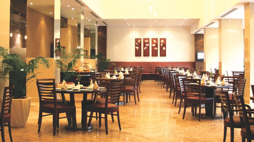 A dining area with tables, chairs and ambient lights.