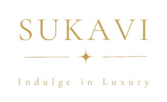 The SUKAVI logo with the tagline Indulge in Luxury featuring clean serif lettering and a small star-like symbol between two horizontal lines.