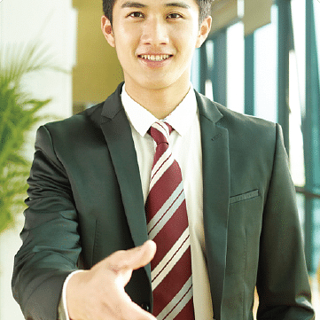 image of a man dressed in business formals approaching for a hand shake