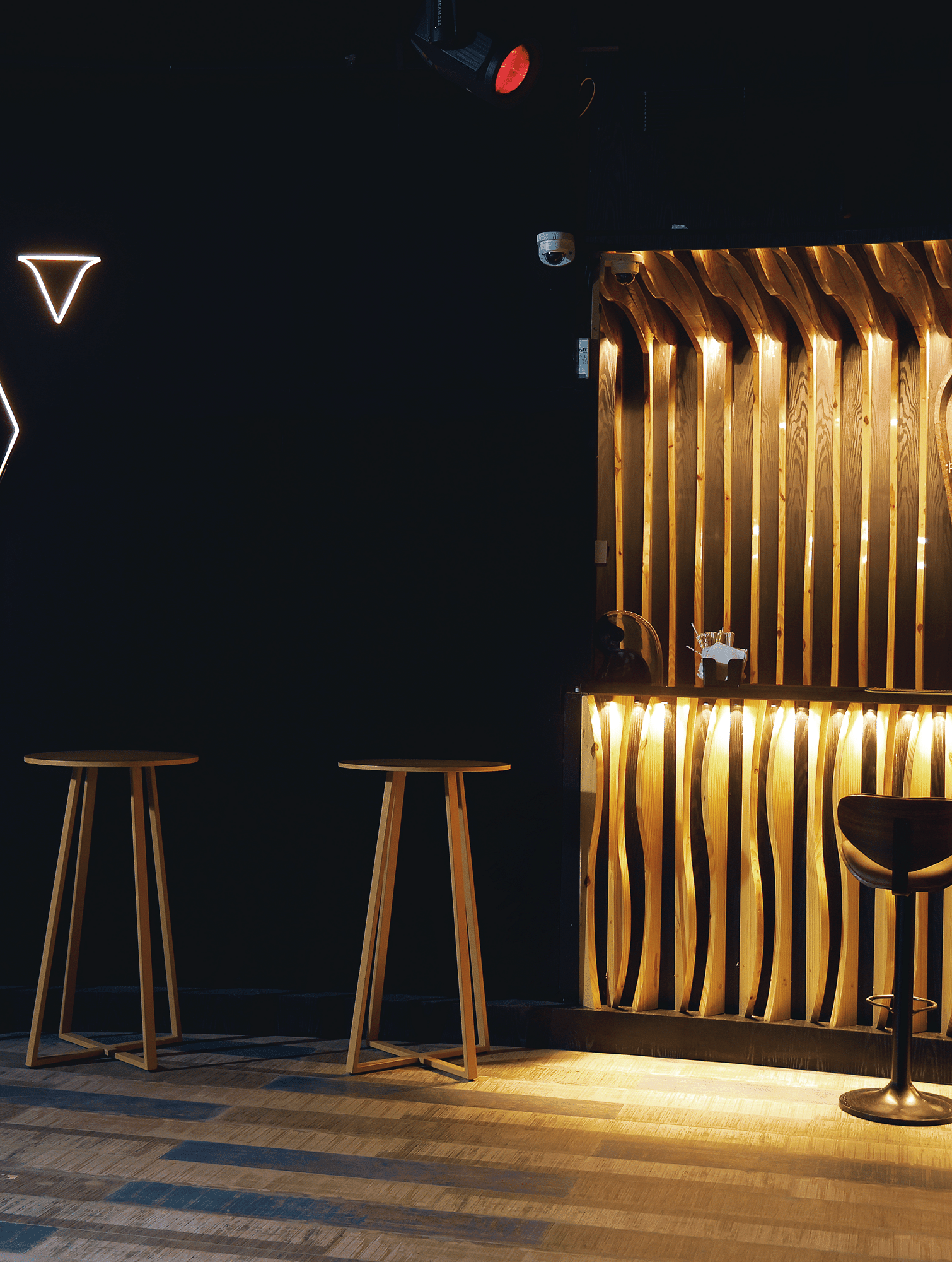 Verve featuring a minimalist logo, warm lighting, and sleek wooden bar stools at The Qualia Resort Club & Brewery, Udaipur.