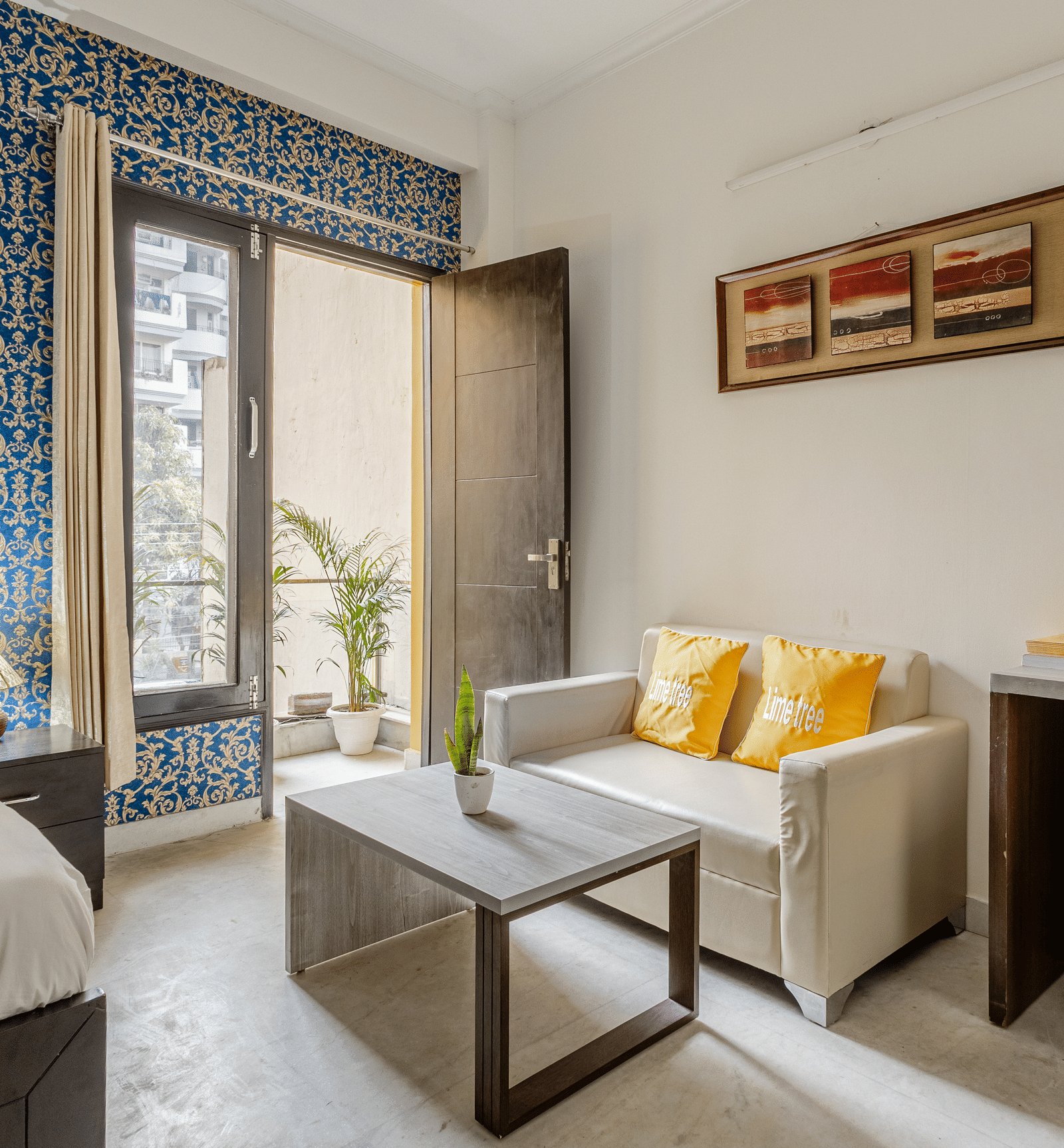 Room view with sofa and entry to balcony at Lime Tree