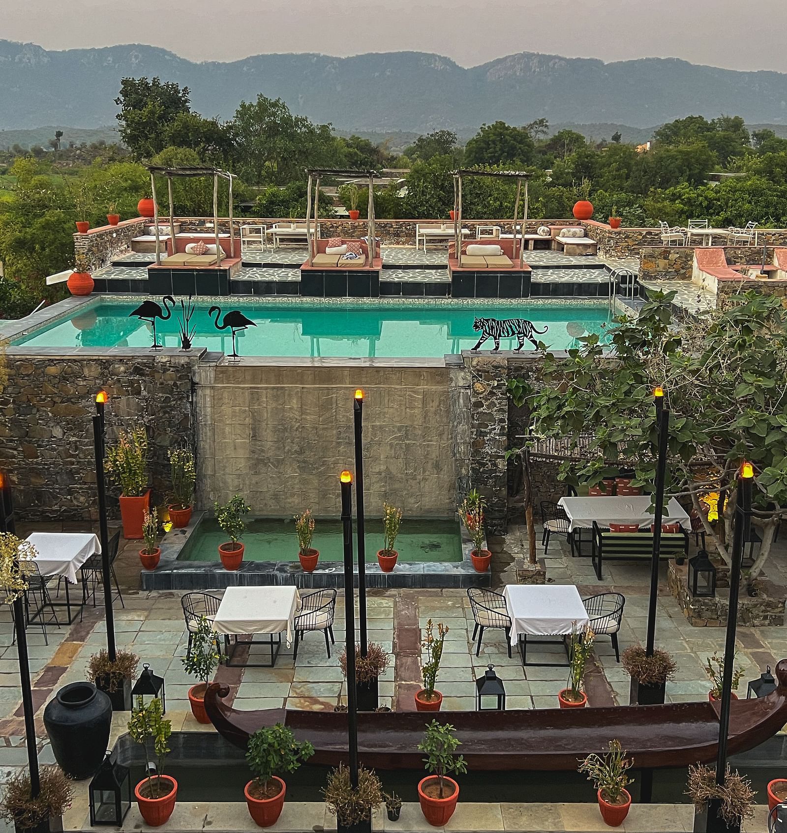 A facade image of the property with a beautiful swimming pool - Utsav Camp.