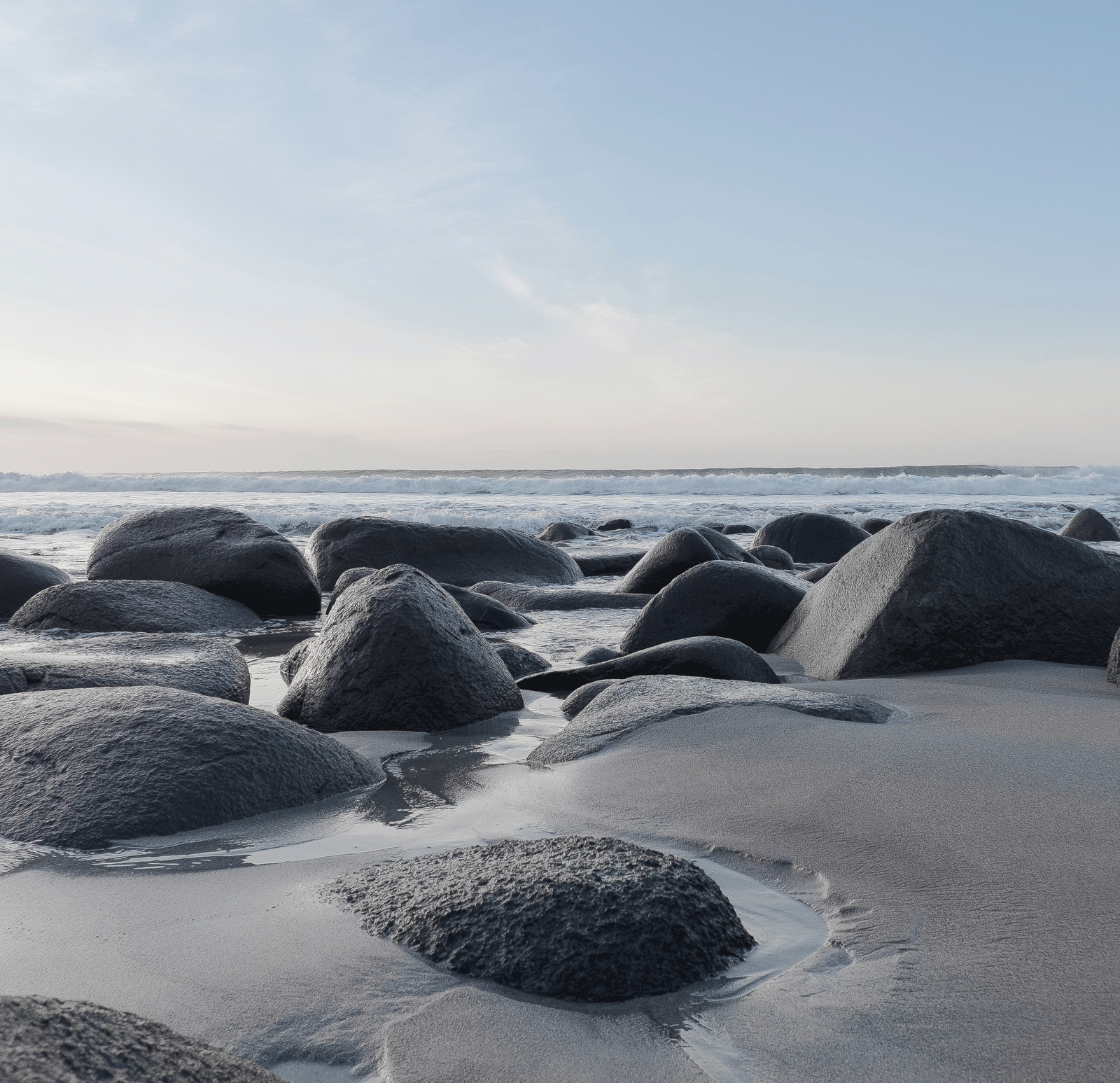 Beach with black rocks and sand at rock beach in Puducherry for the perfect Pondicherry Beach Nightlife.