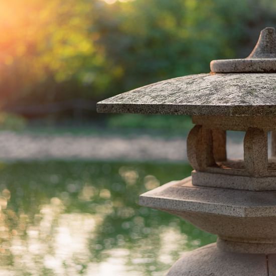 a stone structure by a water body