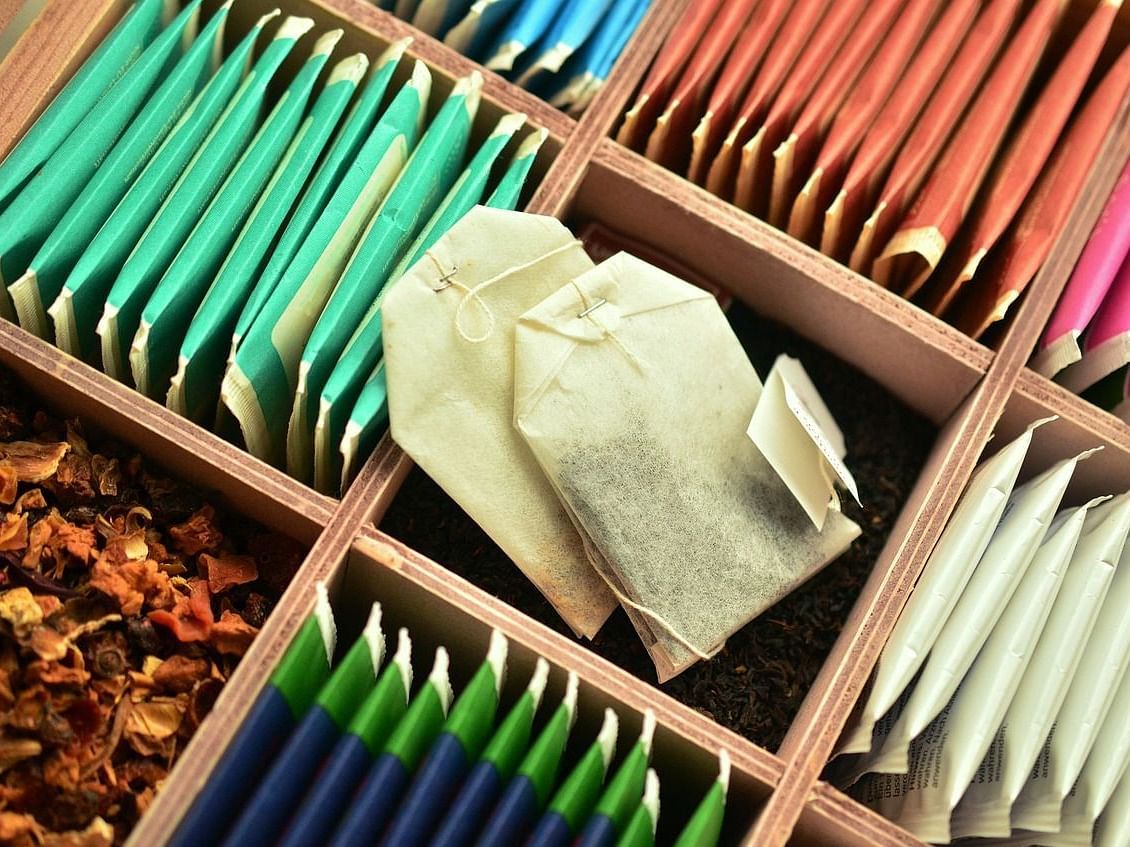 An image showing different flavored tea bags arranged in a tray.