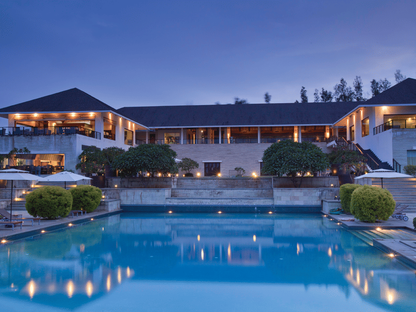 Swimming pool and exterior facade in late evening of The Serai, Chikmagalur.
