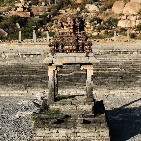 Ancient stone structure in a stepped tank, Hampi