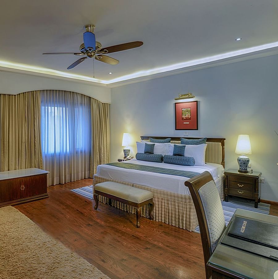 Clarks Varanasi - a sofa set facing the king size bed of the suite in Varanasi