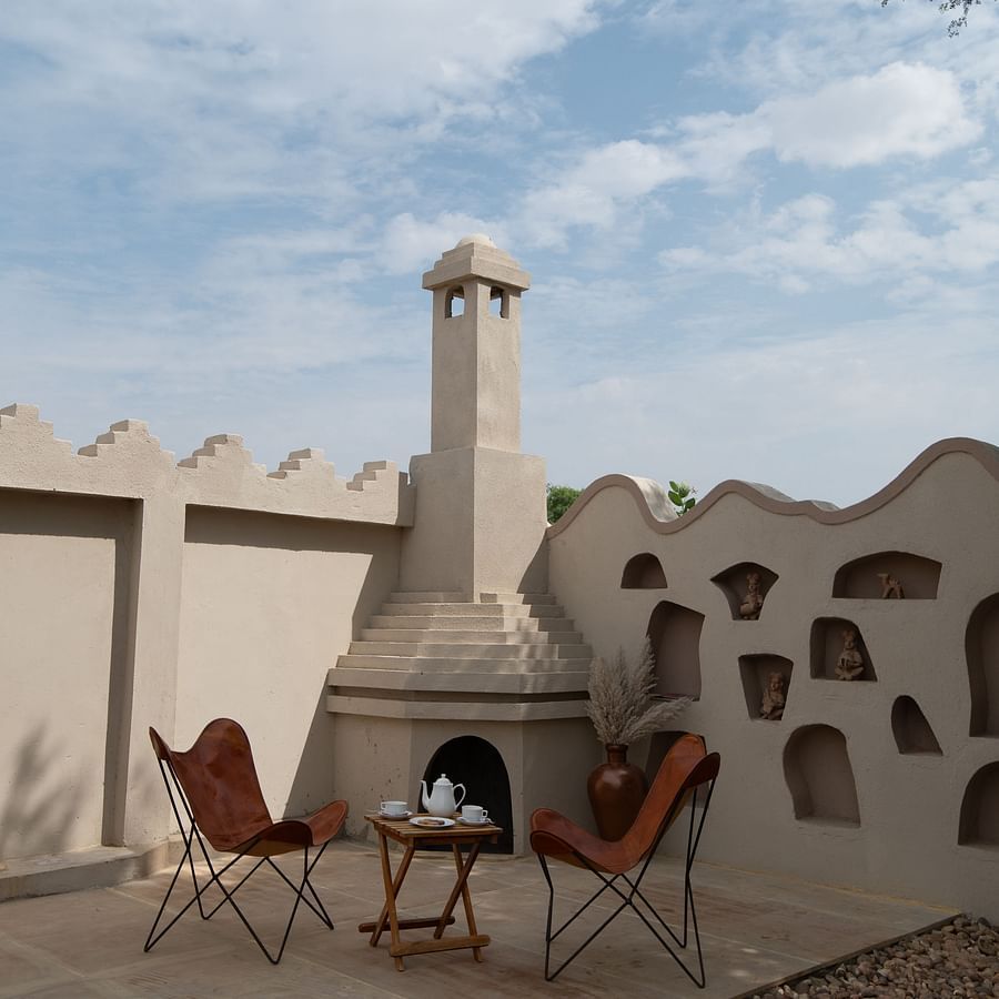 alt-text An image of an outdoor sit out area it two chairs and a table in a terrace