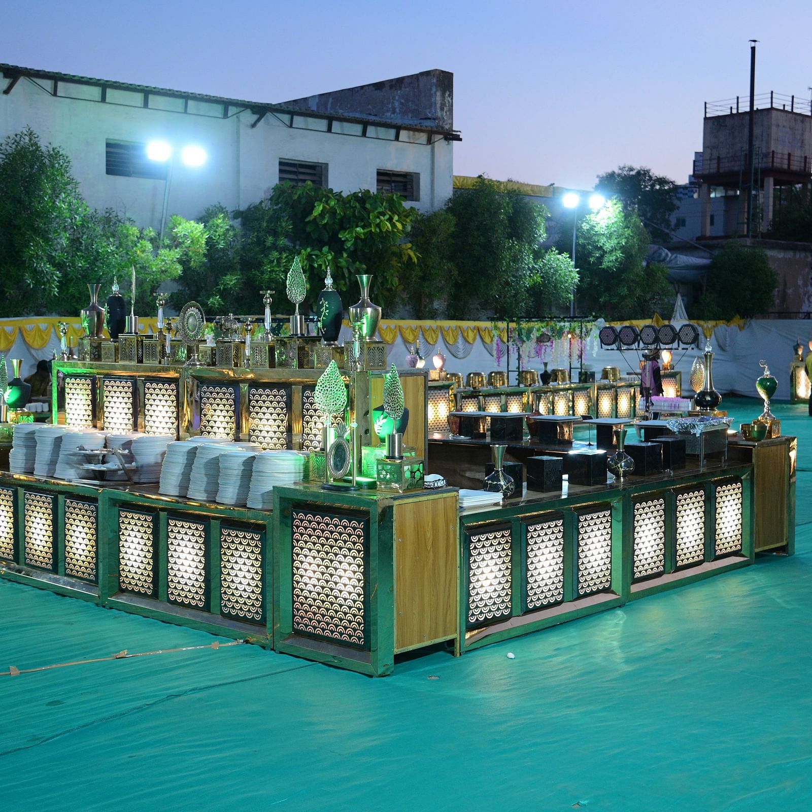 An outdoor buffet set up with decorative lighting in an open event space at Rang Lords Inn Bharuch