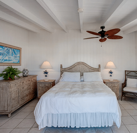 Bedroom with a double bed, ceiling fan, and natural light | Abaco Inn