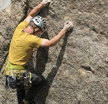 Image of a person rock climbing in the day light