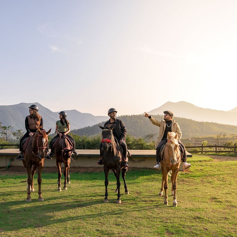 four people riding the horses