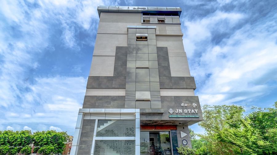 Facade view of Harigovinda's JNStay from the front against a cloudy sky
