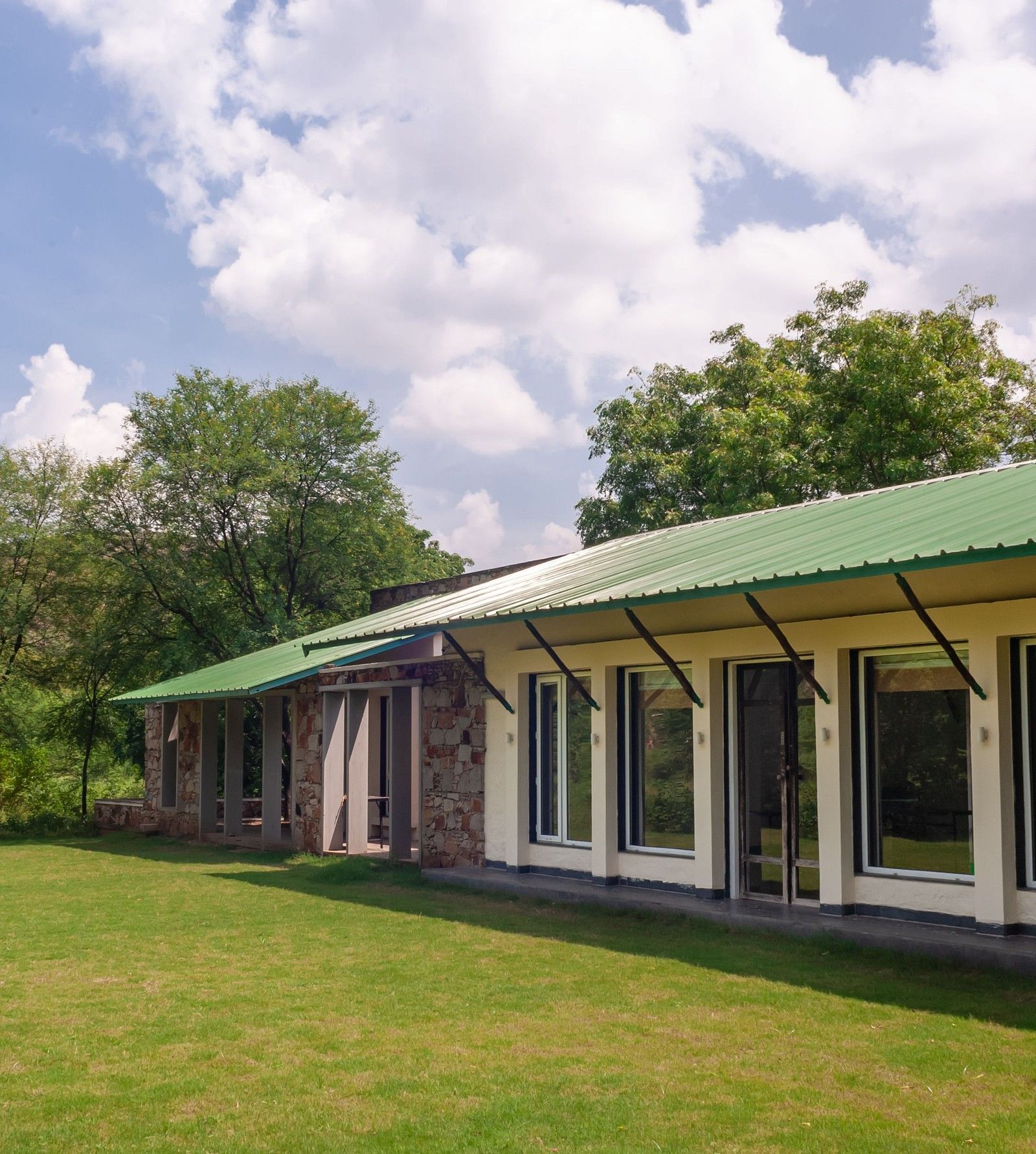 An exterior view of the cottages during the day at Trees N Tigers
