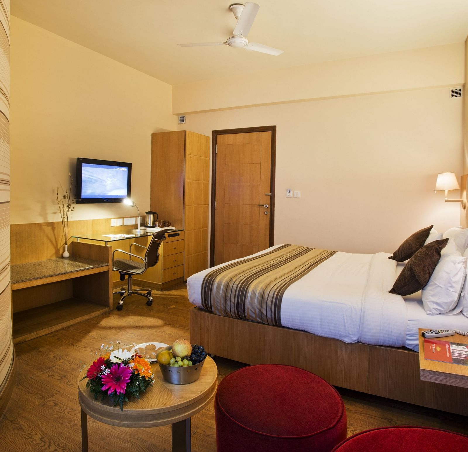 an image of a bedroom with a fan hanging from the ceiling at The Manor, Bareilly