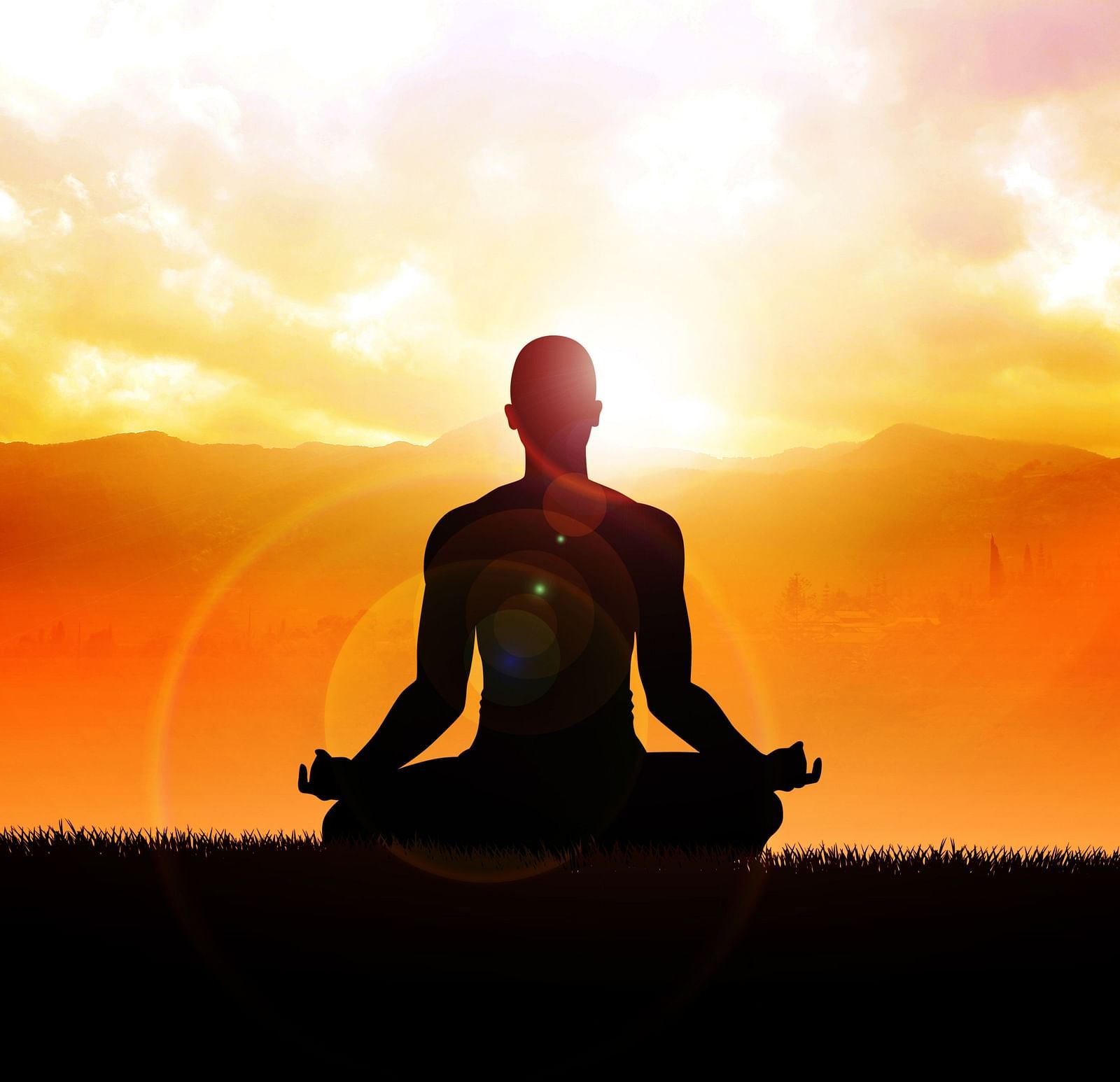 A person performing Yoga and  sunset in the background